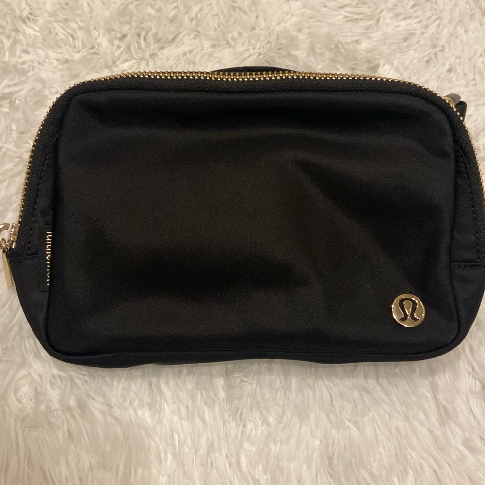 Black Lululemon Everywhere Belt Bag 1L with Gold Hardware.